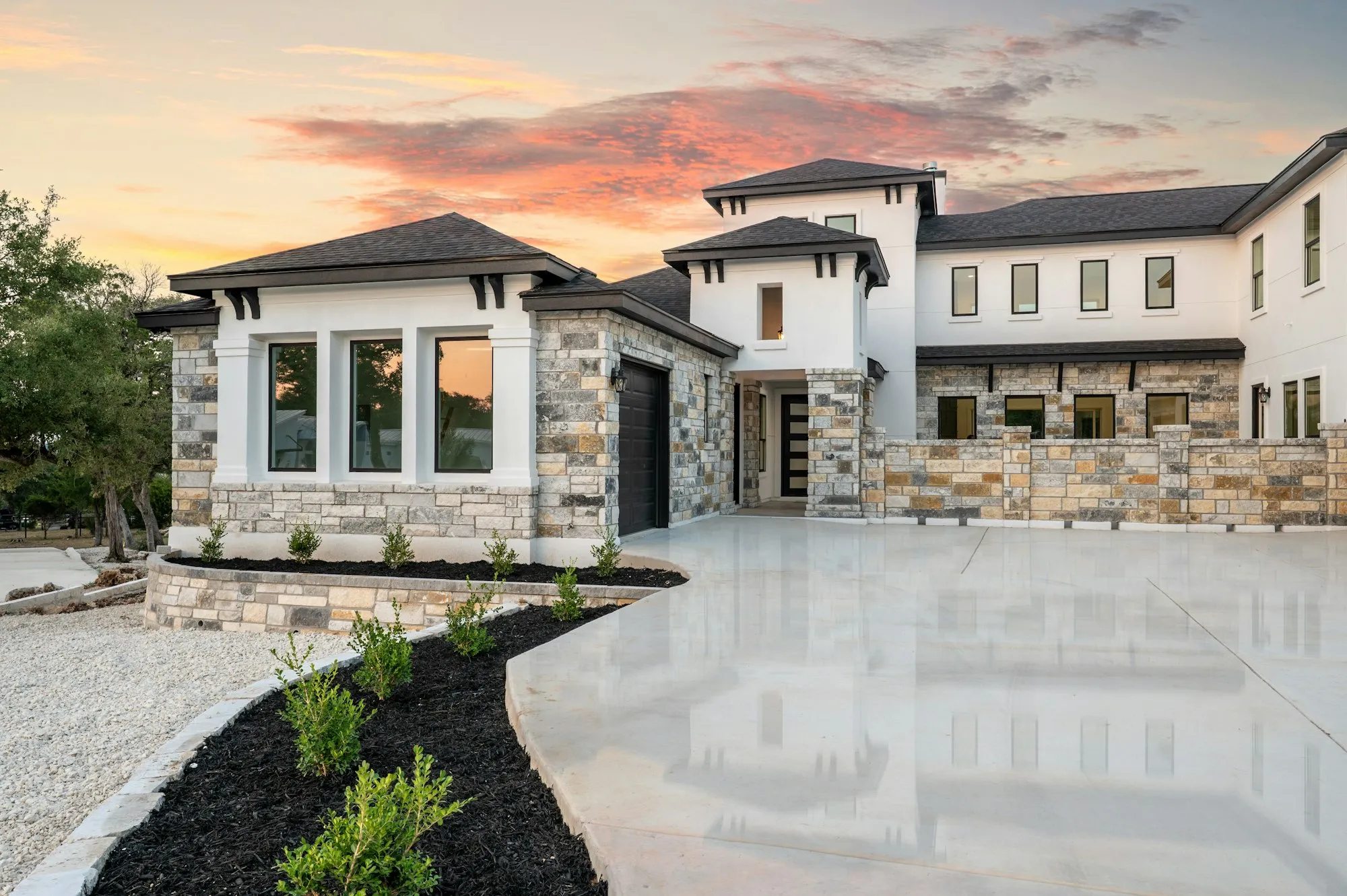 A beautifully finished home exterior at sunset with a new roof